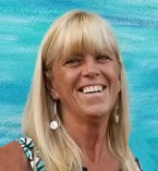 Smiling blonde woman against turquoise background